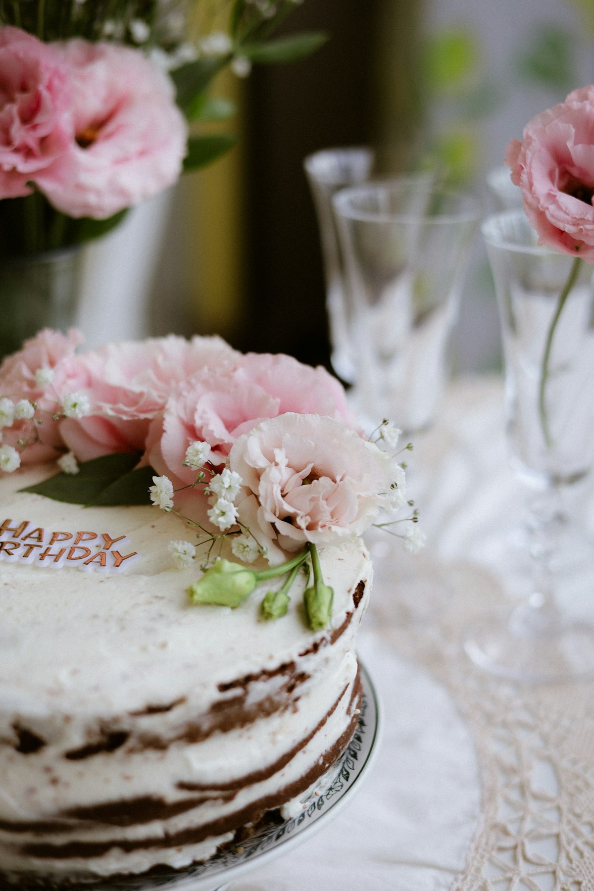 A pink flower-decorated vanilla bean mini cake